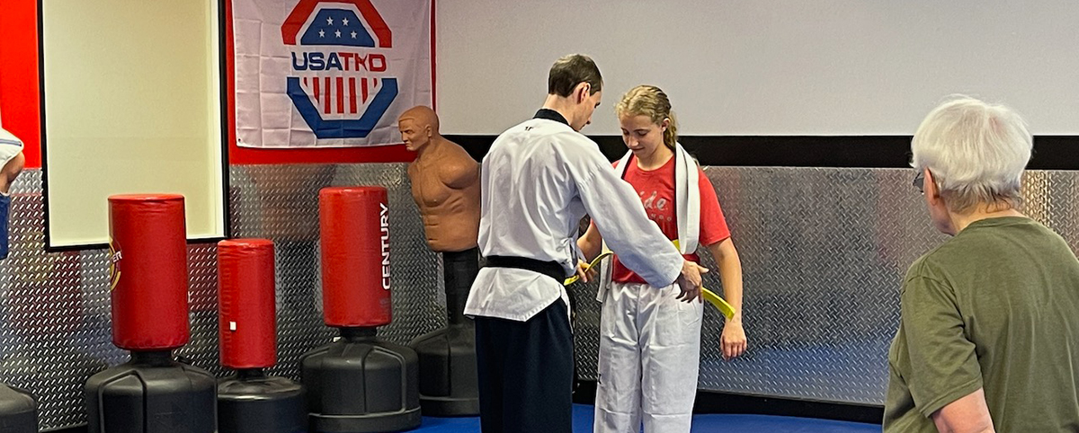 Student receiving a belt